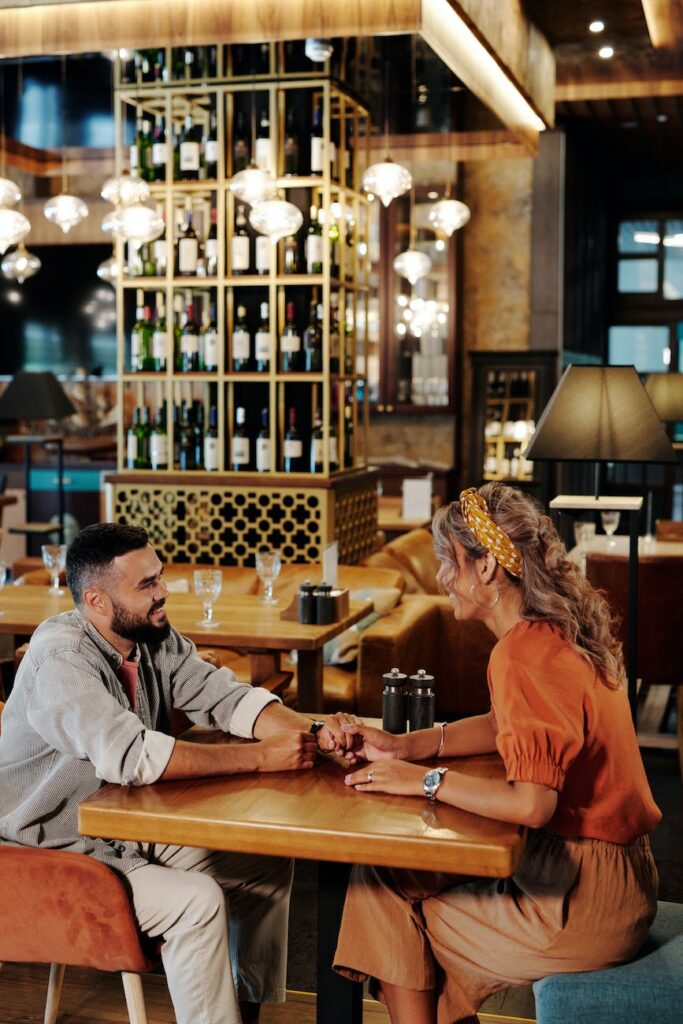 a man and woman sitting inside a retaurant