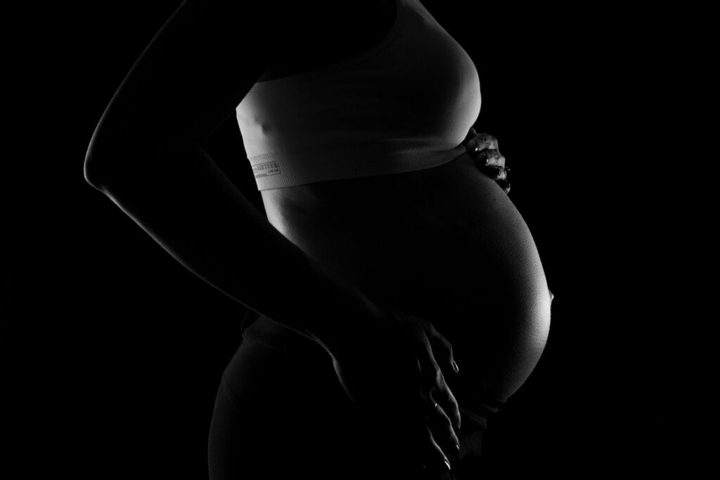 gray scale photo of a pregnant woman