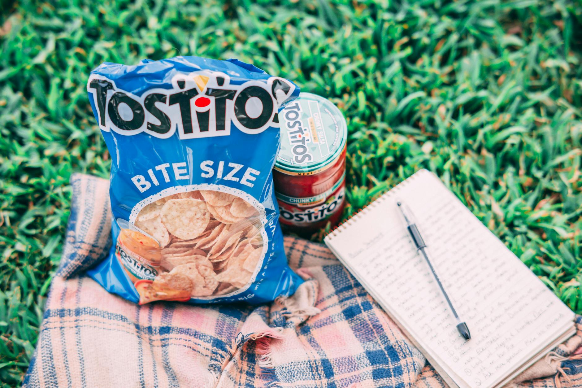 tostito pack beside can and notebook